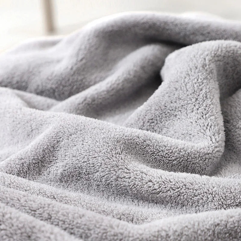 Close-up of a soft gray blanket with a blurred background
