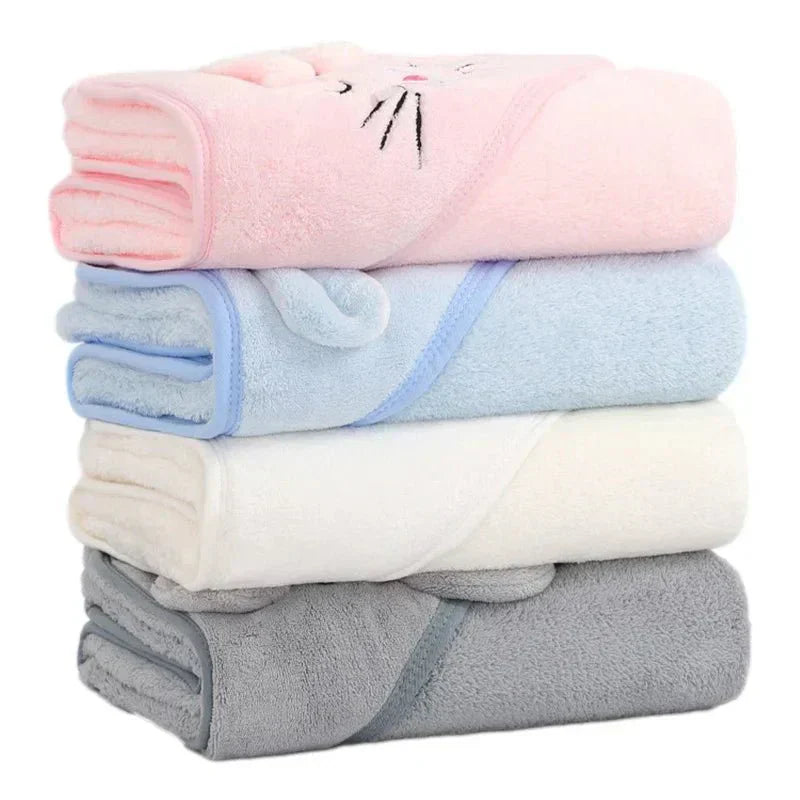 Stack of folded baby blankets in pink, blue, white, and gray on a white background