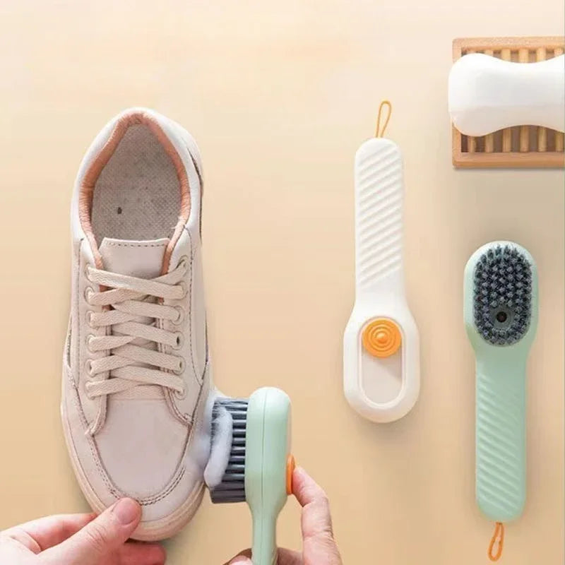 Person cleaning a white sneaker with a brush on a beige background